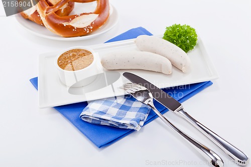 Image of weisswurst white sausages and sweet mustard with pretzel 