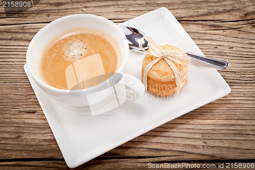 Image of fresh aromatic coffee and cookies on table