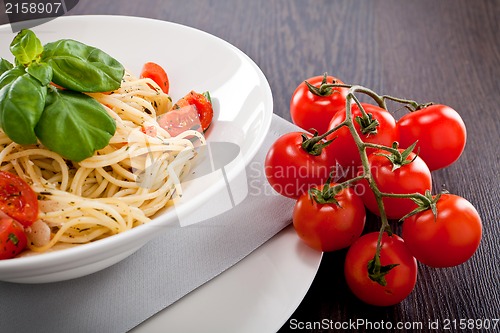 Image of fresh tasty pasta spaghetti with tomatoes and basil