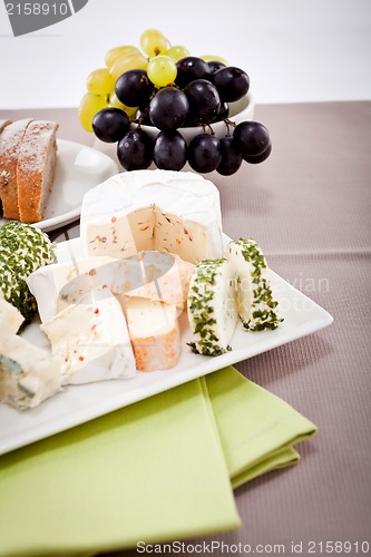 Image of cheese plate with grapes and wine dinner