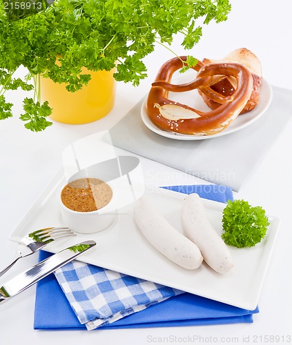 Image of weisswurst white sausages and sweet mustard with pretzel 