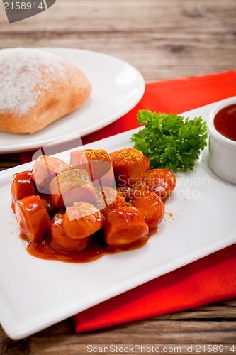 Image of curry wurst spicy sausage with curry and ketchup