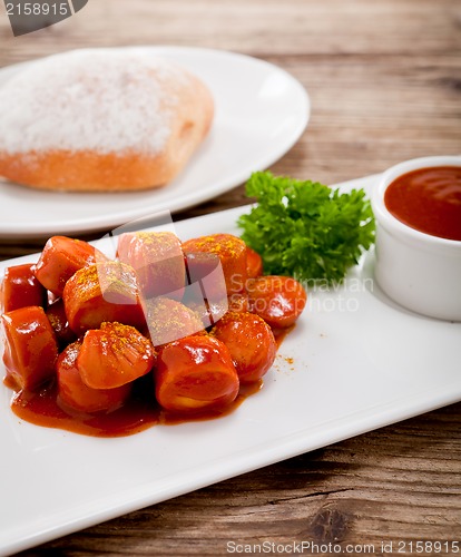 Image of curry wurst spicy sausage with curry and ketchup