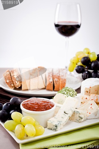 Image of cheese plate with grapes and wine dinner