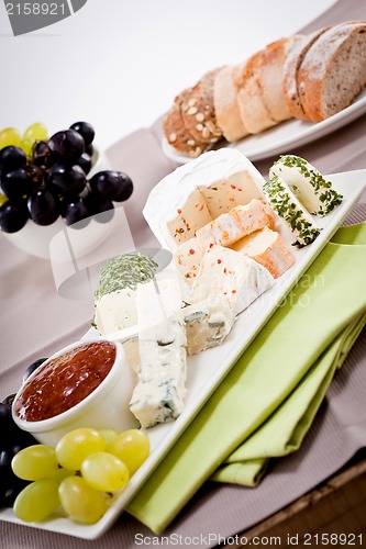 Image of cheese plate with grapes and wine dinner