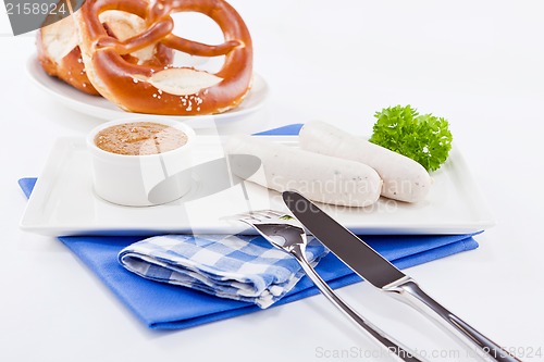 Image of weisswurst white sausages and sweet mustard with pretzel 