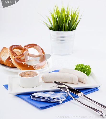 Image of weisswurst white sausages and sweet mustard with pretzel 