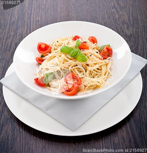 Image of fresh tasty pasta spaghetti with tomatoes and basil