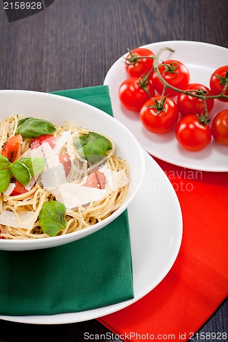 Image of fresh tasty pasta spaghetti with tomatoes and basil