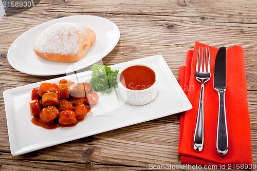 Image of curry wurst spicy sausage with curry and ketchup