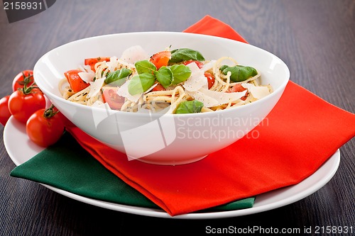 Image of fresh tasty pasta spaghetti with tomatoes and basil