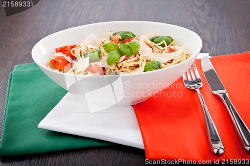 Image of fresh tasty pasta spaghetti with tomatoes and basil