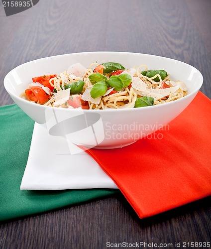 Image of fresh tasty pasta spaghetti with tomatoes and basil