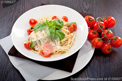 Image of fresh tasty pasta spaghetti with tomatoes and basil