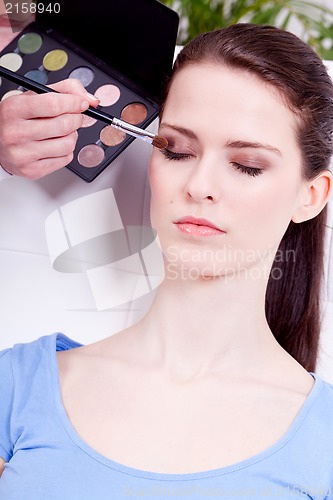 Image of doing the makeup brown eyeshadow on beautiful eyes