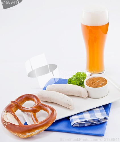 Image of weisswurst white sausages and sweet mustard with pretzel 