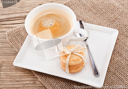 Image of fresh aromatic coffee and cookies on table