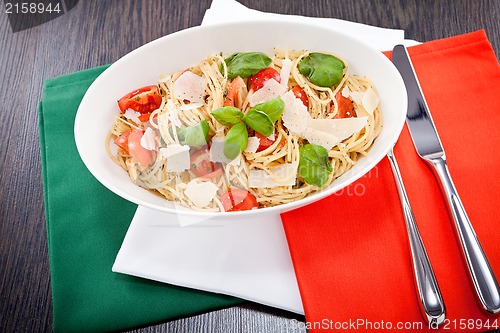 Image of fresh tasty pasta spaghetti with tomatoes and basil