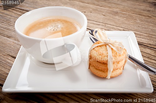 Image of fresh aromatic coffee and cookies on table