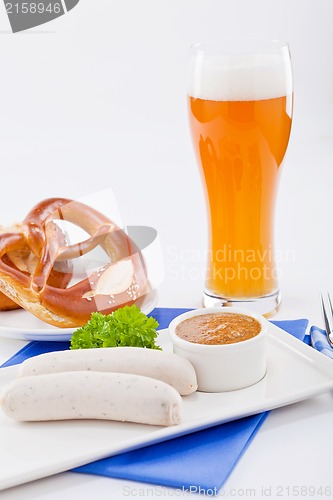 Image of weisswurst white sausages and sweet mustard with pretzel 