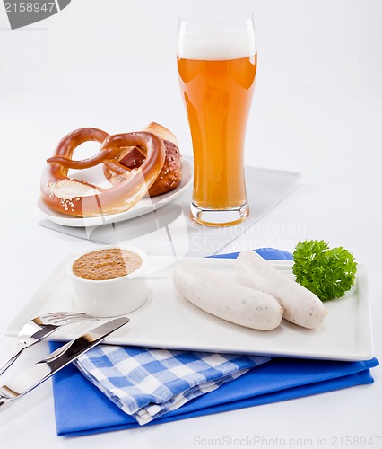 Image of weisswurst white sausages and sweet mustard with pretzel 