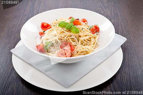 Image of fresh tasty pasta spaghetti with tomatoes and basil