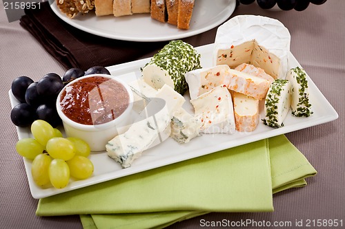 Image of cheese plate with grapes and wine dinner