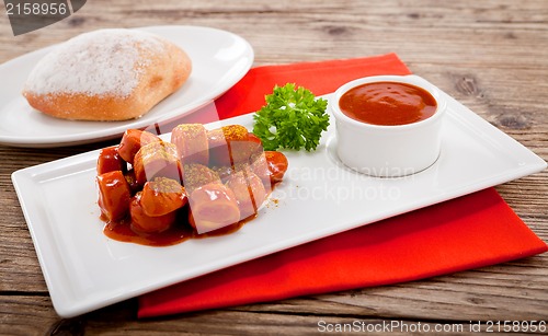 Image of curry wurst spicy sausage with curry and ketchup