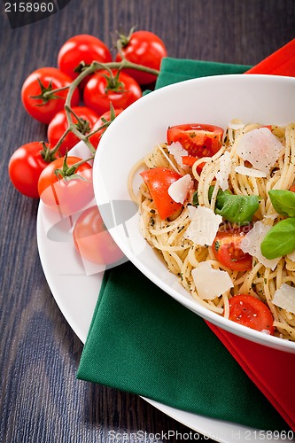 Image of fresh tasty pasta spaghetti with tomatoes and basil