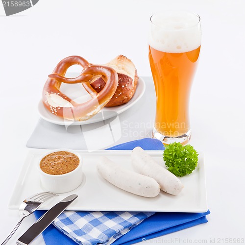 Image of weisswurst white sausages and sweet mustard with pretzel 