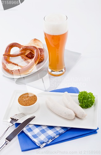 Image of weisswurst white sausages and sweet mustard with pretzel 