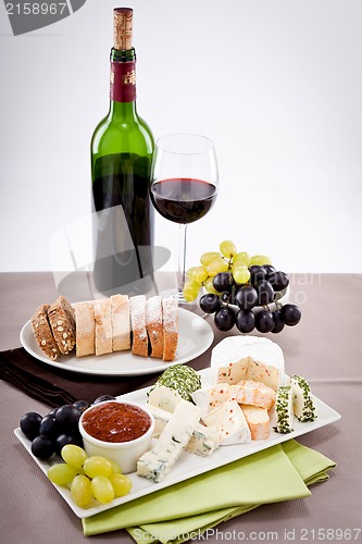 Image of cheese plate with grapes and wine dinner