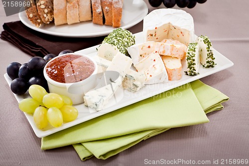 Image of cheese plate with grapes and wine dinner