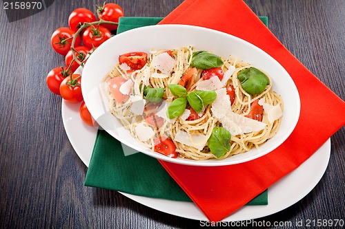 Image of fresh tasty pasta spaghetti with tomatoes and basil