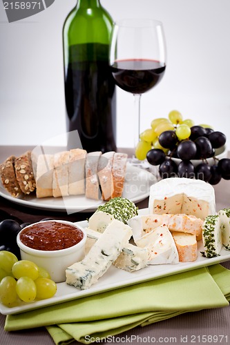 Image of cheese plate with grapes and wine dinner