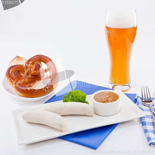 Image of weisswurst white sausages and sweet mustard with pretzel 