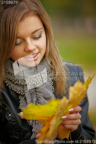 Image of Beautiful girl in the autumn park