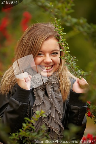 Image of Beautiful positive girl in the bushes Viburnum