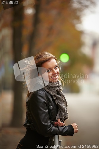 Image of Beautiful girl in autumn city