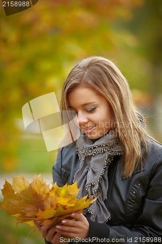 Image of Beautiful girl in the autumn park