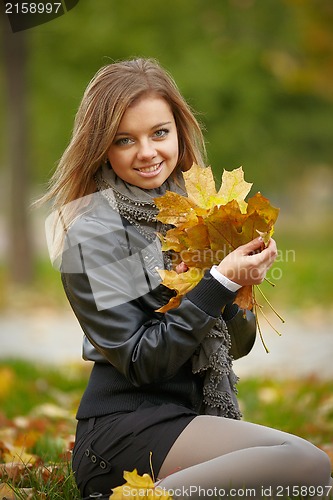 Image of Beautiful girl in the autumn park