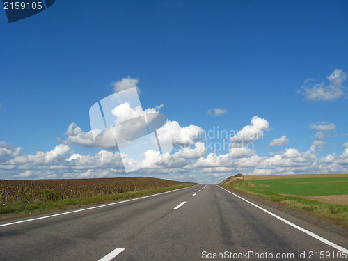 Image of asphalted road and the blue sky