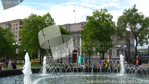 Image of People have a rest in park with fountains