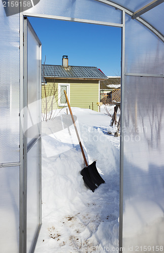 Image of View of a country house inside the greenhouse winter day