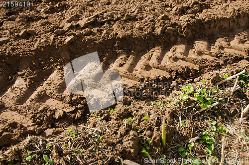 Image of tractor mark trail soil agriculture field 