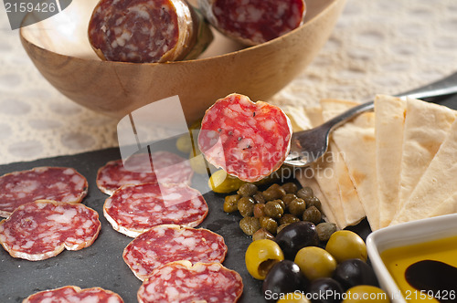 Image of cold cut platter with pita bread and pickles