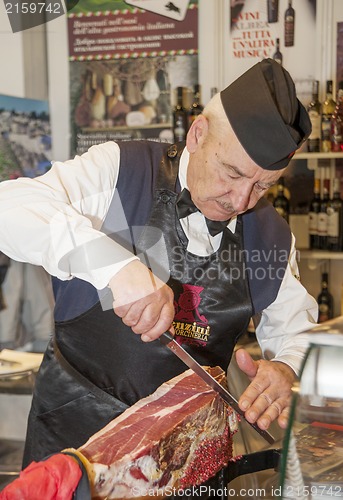 Image of Man cutting a ham 