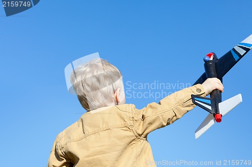 Image of boy holding a plane