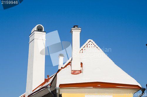 Image of Chimneys and roof brought by a snow, a close up