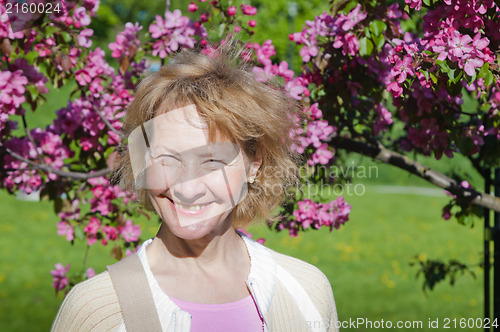 Image of a middle-aged woman in a blossoming magnolias